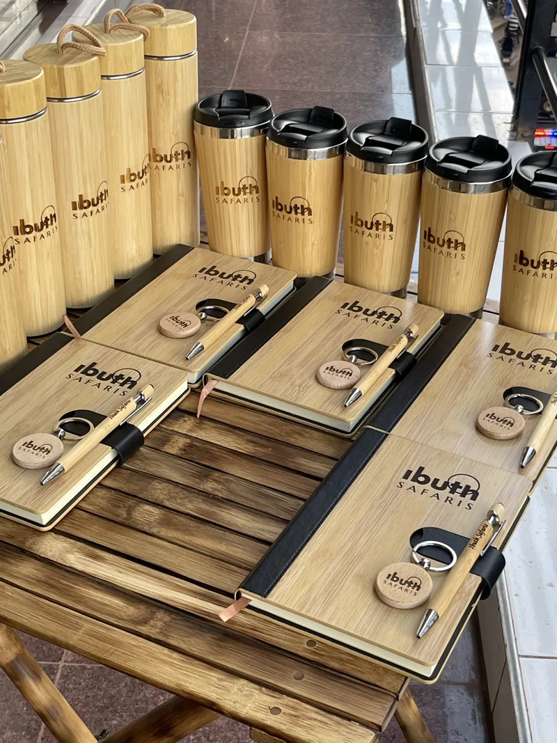 A table of branded bamboo bottles, mugs and notebooks