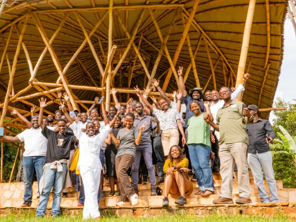 A group cheering under a bamboo dome