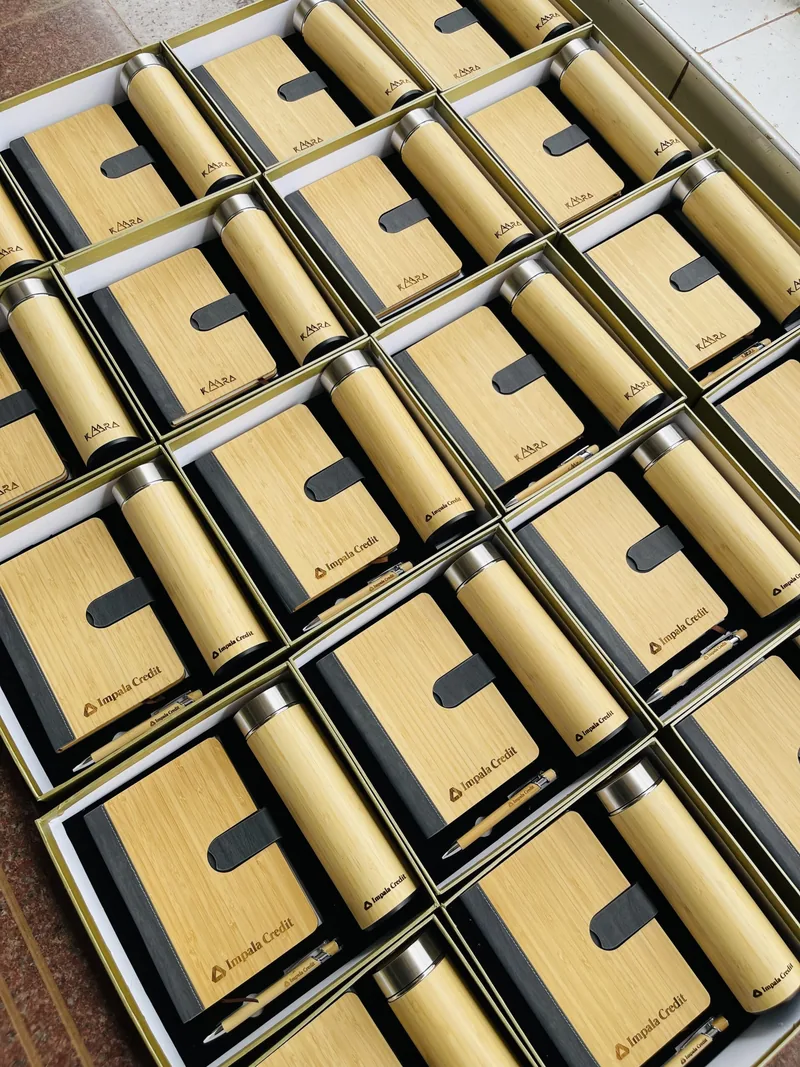 Rows of boxed gift sets, each a bamboo notebook and bottle
