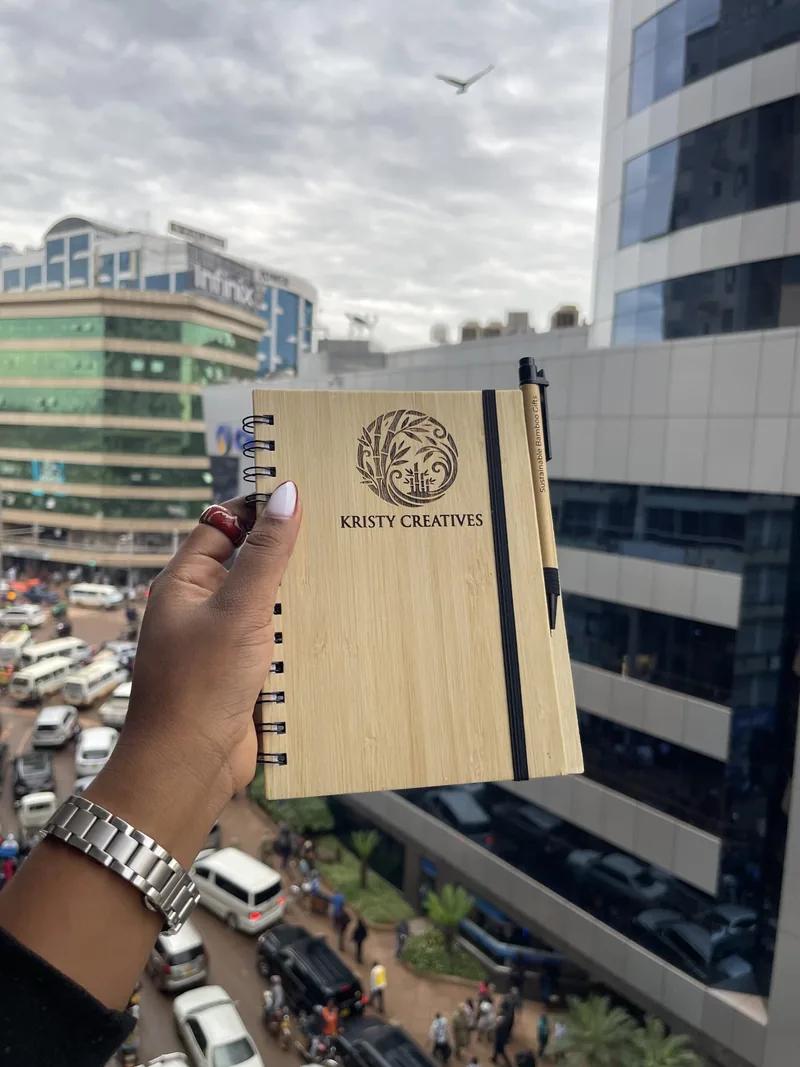A bamboo-cover journal held over the city